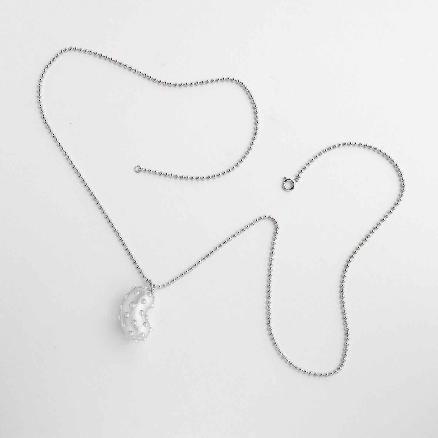 Silver bean pendant with playful pimples. Rhodium plated silver