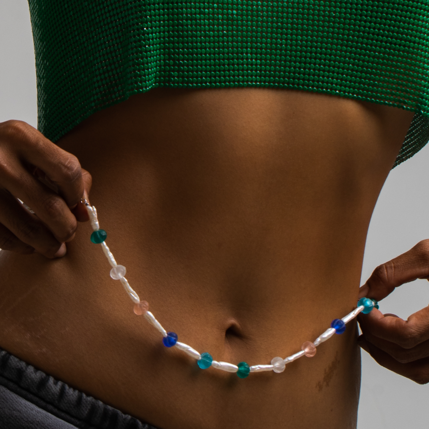 model wearing a necklace "Recycled Elegance". Made of Old beads, Freshwater pearls and rhodium plated Silver 925.