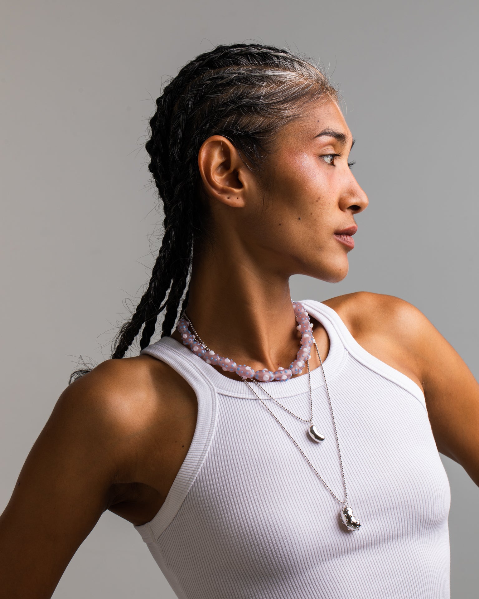 model wearing a bean pendant made of rhodium-plated silver