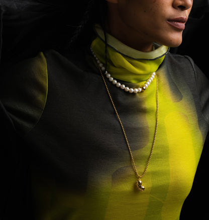 A model wearing Golden ball chain made of Gold plated silver with bean pendant YOOCHI