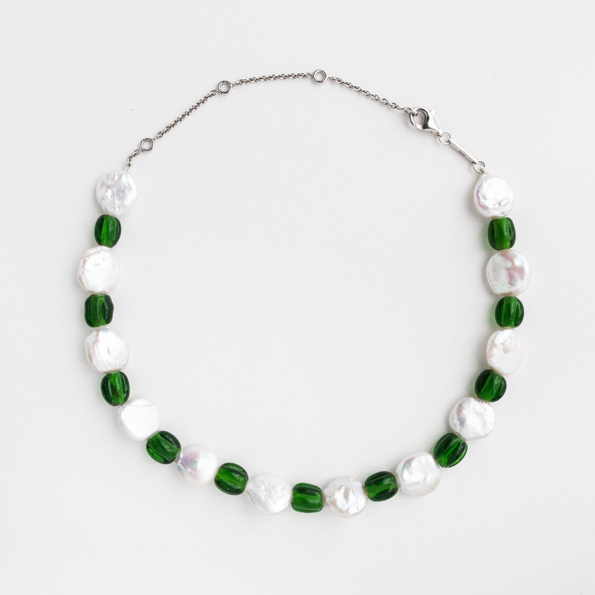 The name а the product is "Green old choker". It's made of Old glass beads, Freshwater pearls and Silver 925 rhodium plated.