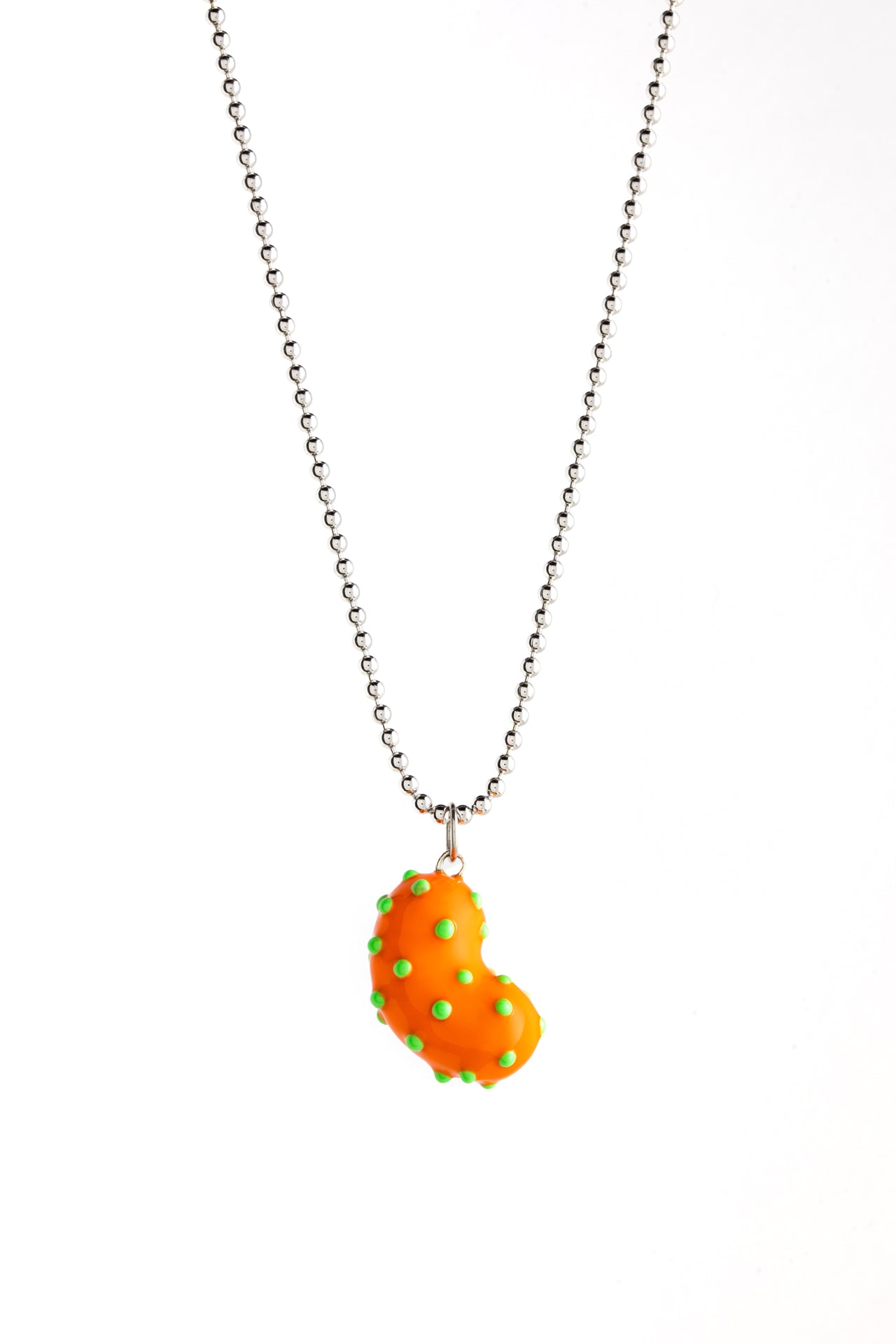 A silver bean pendant enveloped in lush orange enamel, accented with playful green dots