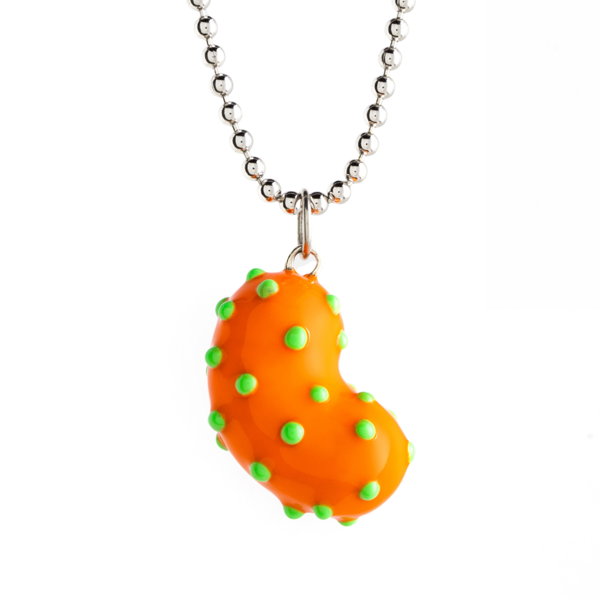 A silver bean pendant enveloped in lush orange enamel, accented with playful green dots