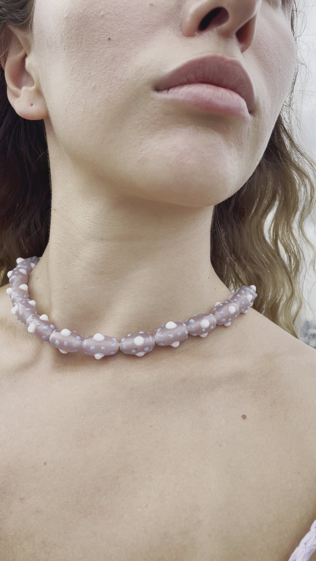 Model wearing beaded choker which is inspired by the beauty of tentacles. Each bead was blown by hand so each bead is unique and might slightly differs from each other.